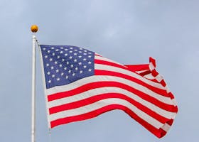 A vibrant image of the American flag waving proudly against a clear blue sky, symbolizing freedom.